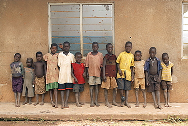 An IDP camp (internally displaced people) in Amuru district of Northern Uganda has been created to accommodate the mass of Ugandan refugees fleeing the LRA (Lords Resistance Army) who are fighting the Ugandan government and its people.  Here you can see some of the many children, lined up by their school building. Amuru, Uganda, East Africa