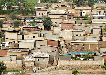 Like a patchwork quilt covering many of the steep hills of Kigali, this housing in some of the poorer areas of Kigali house a high proportion of the population and are commonplace throughout the Capitol City. Kigali, Rwanda, East Africa