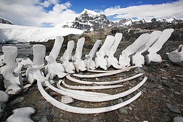 The old British Whaling Station at Port Lockroy and the whalebones across the bay at Point Jougla near Weincke Island, Antarctica.