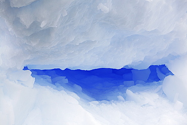 Detail of an intensely blue iceberg adrift in Antarctica.