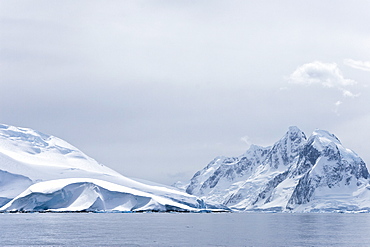 Snow covered mountains near Petermann Island on the west side of the Antarctic Peninsula.