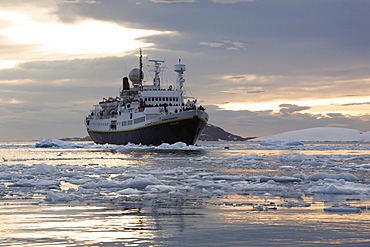 The National Geographic Endeavour pushing through brash ice and small icebergs in the Lemaire Channel near the Antarctic Peninsula.