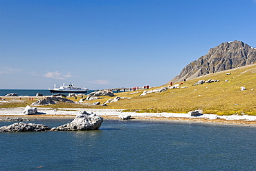 Hikers returning to the National Geographic Endeavour in Hornsund (Horn Sound) on the southwestern side of Spitsbergen Island in the Svalbard Archipelago, Barents Sea, Norway