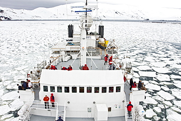 The Lindblad expedition ship National Geographic Endeavour operating in shre fast ice in Port Foster within the caldera at Deception Island, South Shetland Island Group, Antarctica.