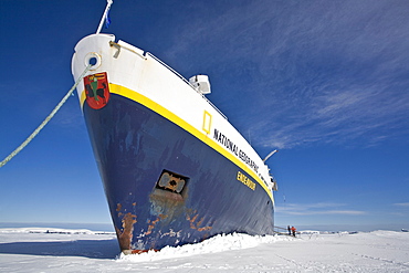 The Lindblad expedition ship National Geographic Endeavour stuck hard and fast in shore fast ice in Port Foster, Deception Island, Antarctica.