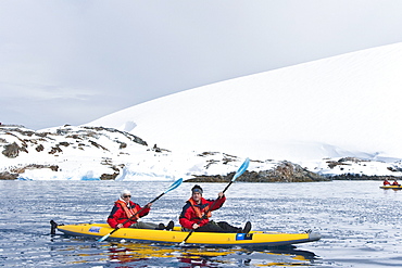 Lindblad Expeditions guests kayaking at Petermann Island in Antarctica as part of expedition travel. NO MODEL RELEASES FOR THIS IMAGE.