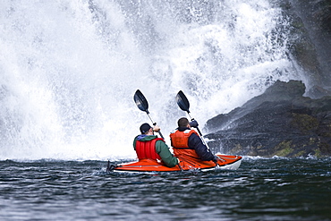 Kayaking in Red Bluff Bay on Baranof Island in Southeast Alaska, USA. Pacific Ocean. Kayak property release is DB051905. Model released numbers BM0807, JP0807, or DP0807.