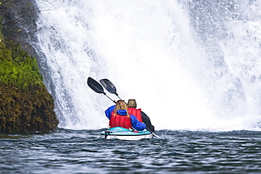 Kayaking in Red Bluff Bay on Baranof Island in Southeast Alaska, USA. Pacific Ocean. Kayak property release is DB051905. Model released numbers BM0807, JP0807, or DP0807.