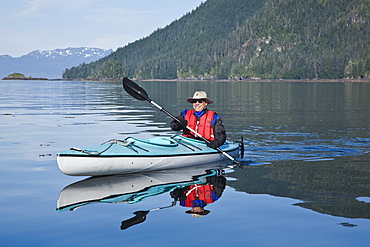 Kayaking in Windham Bay in Southeast Alaska, USA. Pacific Ocean. Kayak property release is DB051905. No model release.