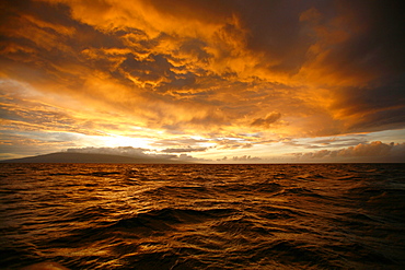 Sunset across the AuAu Channel between Maui and Lanai, looking west with Lanai in the background. Maui, Hawaii, USA.