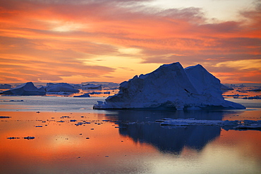 Sunset on fresh sea ice and tabular icebergs in the Weddell Sea, Antarctica.