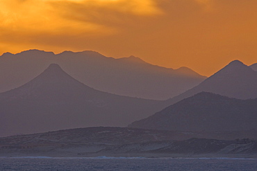 Sunset over the southern Baja Peninsula in Baja California Sur, Mexico. This photo is taken from a boat on the Gulf of California (Sea of Cortez) side of the peninsula.