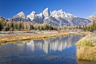 Reflected light on water from the Grand Teton Mountain Range, outside of Jackson Hole, Wyoming. This image was shot from the Schabawacker Landing on the snake river.