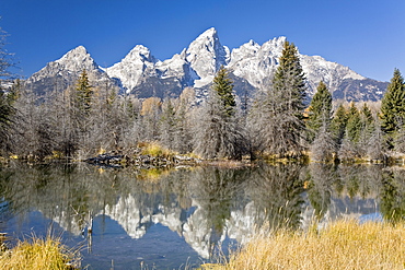 Reflected light on water from the Grand Teton Mountain Range, outside of Jackson Hole, Wyoming. This image was shot from the Schabawacker Landing on the snake river.