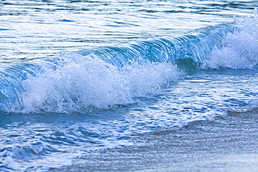 Waves breaking on the beach at Batolome Island in the Galapagos Island Archipeligo, Ecuador. Pacific Ocean.