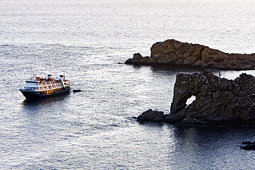 Sunset on the National Geographic Sea Bird and the eye of elephant rock on the southern end of Isla Santa Catalina in the Gulf of California (Sea of Cortez), Baja California Sur, Mexico