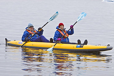 Guests from the Lindblad Expedition ship National Geographic Endeavour kayaking in and around the Antarctic Peninsula in the summer months. No property or model releases available for this image.