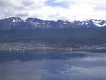 Aerial views of snow-capped mountains, ice fields, and glaciers on a charter flight from Santiago, Chile to Ushuaia, Argentina