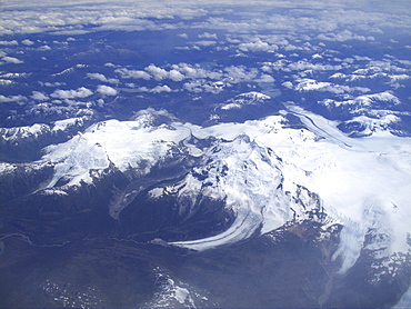 Aerial views of snow-capped mountains, ice fields, and glaciers on a charter flight from Santiago, Chile to Ushuaia, Argentina