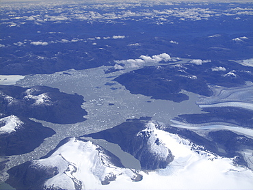 Aerial views of snow-capped mountains, ice fields, and glaciers on a charter flight from Santiago, Chile to Ushuaia, Argentina