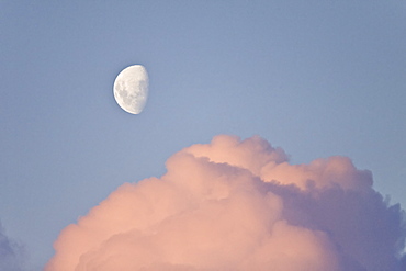 The Lindblad Expedition ship National Geographic Explorer in Dahlman Bay in late evening light as the waxing moon rises on the west side of the Antarctic Peninsula in Antarctica. 