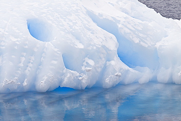 The Lindblad Expeditions ship National Geographic Explorer pushes through ice in Crystal Sound, south of the Antarctic Circle