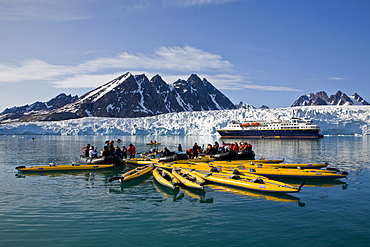 Guests from the Lindblad Expedition ship National Geographic Explorer kayaking near Monaco Glacier on Spitsbergen Island in the Svalbard Archipelago