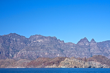 Isla Danzante in front of Las Gigantas mountain range from the Gulf of California (Sea of Cortez) just outside of Loreto, Baja California Sur, Mexico. 