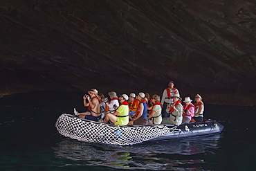 Lindblad Expeditions Guests exploring a sea grotto in the Galapagos Island Archipeligo, Ecuador. No model or property release are available for this image.