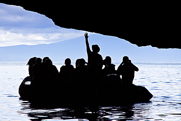 Lindblad Expeditions Guests exploring a sea grotto by Zodiac in the Galapagos Island Archipeligo, Ecuador. No model or property release are available for this image.