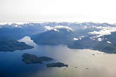 Low clouds and dramatic light on a commercial flight between Sitka and Juneau in Southeast Alaska, USA. Pacific Ocean.