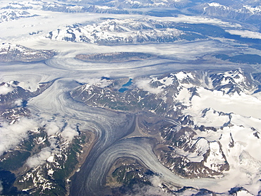 Aerial views of snow-capped mountains, ice fields, and glaciers on a commercial flight from Juneau to Anchorage Alaska, USA, Pacific Ocean