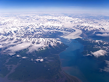 Aerial views of snow-capped mountains, ice fields, and glaciers on a commercial flight from Juneau to Anchorage Alaska, USA, Pacific Ocean