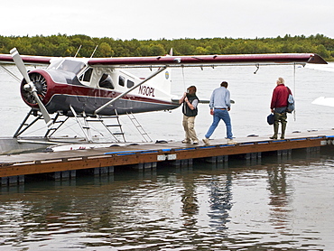 Small float planes being used to shuttle bear watchers between the town of King Salmon and a bear watching lodge at Brooks Camp in Katmai National Park, Alaska, USA. Pacific Ocean.