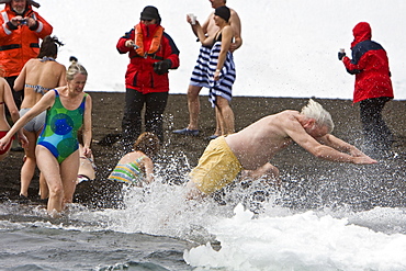 Lindblad Expeditions guests doing the "polar Plunge" in Port Foster near Whalers Bay inside the caldera on Deception Island, South Shetland Island Group, Antarctica. NO MODEL RELEASES FOR THIS IMAGE.