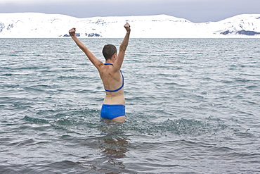 Lindblad Expeditions guests doing the "polar Plunge" in Port Foster near Whalers Bay inside the caldera on Deception Island, South Shetland Island Group, Antarctica. NO MODEL RELEASES FOR THIS IMAGE.