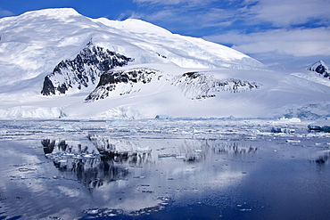 The Lindblad Expeditions ship National Geographic Explorer pushes through ice in Crystal Sound, south of the Antarctic Circle, Antarctica, Southern Ocean