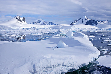 The Lindblad Expeditions ship National Geographic Explorer pushes through ice in Crystal Sound, south of the Antarctic Circle, Antarctica, Southern Ocean