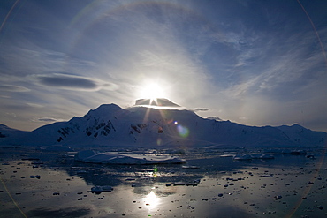 The Lindblad Expeditions ship National Geographic Explorer pushes through ice in Crystal Sound, south of the Antarctic Circle, Antarctica, Southern Ocean