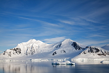 The Lindblad Expeditions ship National Geographic Explorer pushes through ice in Crystal Sound, south of the Antarctic Circle, Antarctica, Southern Ocean