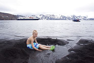 Guests from the Lindblad Expedition ship National Geographic Explorer lay in the relatively warm waters of the caldera at Deception Island, South Shetland Islands, Antarctica