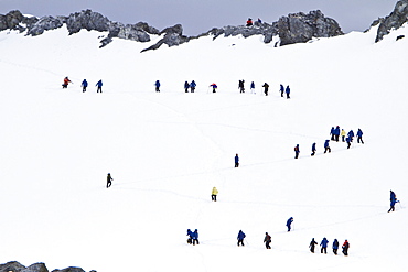 Guests from the Lindblad Expedition ship National Geographic Explorer climb steep snow trail at Orne Harbor, Antarctica