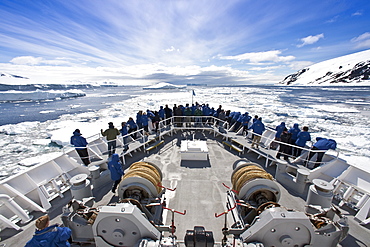 The Lindblad Expedition Ship National Geographic Explorer pushing through pack and sea ice in Antarctica in the summer months.