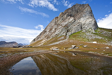 A view of the towering cliff at Gn%lodden in Hornsund (Horn Sound) on the southwestern side of Spitsbergen Island in the Svalbard Archipelago, Barents Sea, Norway.