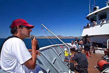 Staff member Mike Greenfelder from the Lindblad Expedition ship National Geographic Sea Bird talking with guests near the Baja Peninsula. 