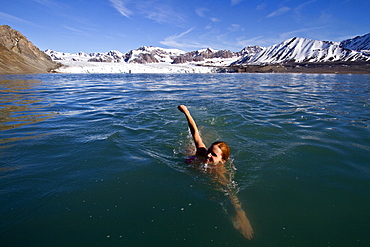 Guests from the Lindblad Expedition ship National Geographic Explorer taking the "polar plunge" in the Svalbard Archipelago, Norway