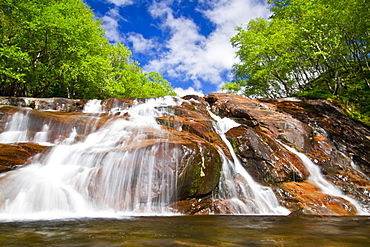 A beautiful waterfall just outside the small Norwegian summer area in Sandvika Bay on the south side of Svesfjord, Norway.