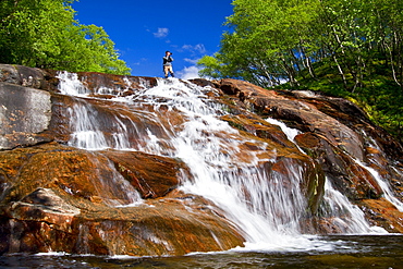 A beautiful waterfall just outside the small Norwegian summer area in Sandvika Bay on the south side of Svesfjord, Norway.