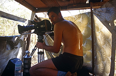 Cameraman, Mike Pitts, on Komodo Island in hide waiting to film Komodo dragons.