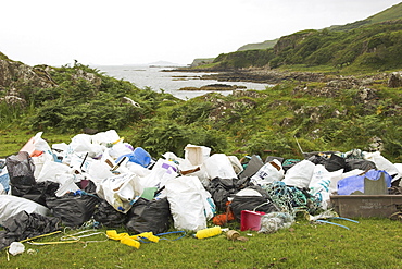 Piles of rubbish collected from beach beyond, Torloisk beach, Isle of Mull, Scotland   (RR)